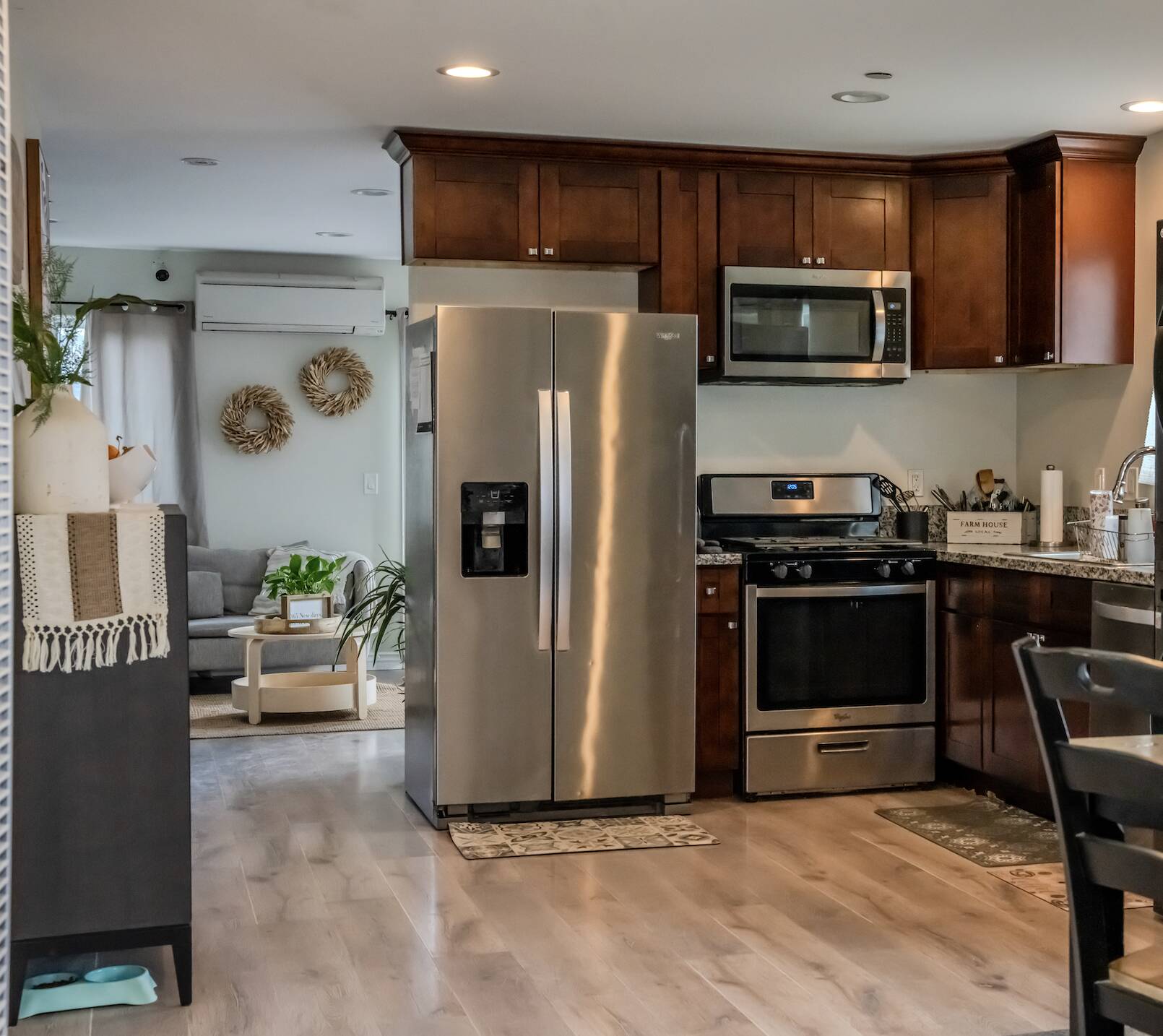 Modern kitchen and living area at Fresh Start of California, featuring stainless steel appliances, wood cabinetry, and a cozy, home-like recovery environment